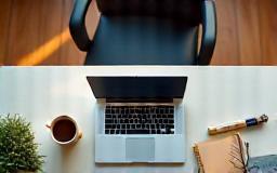 Remote work setup with laptop and coffee in bright room